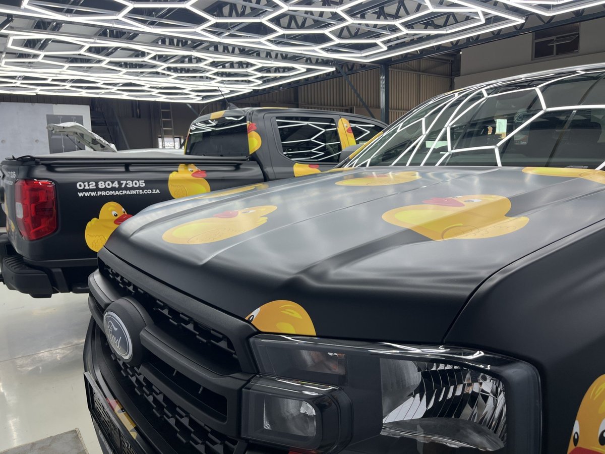 Promac Paints fleet branding — row of black Ford Rangers with Promac duck graphics by Imagine Graffix Pretoria